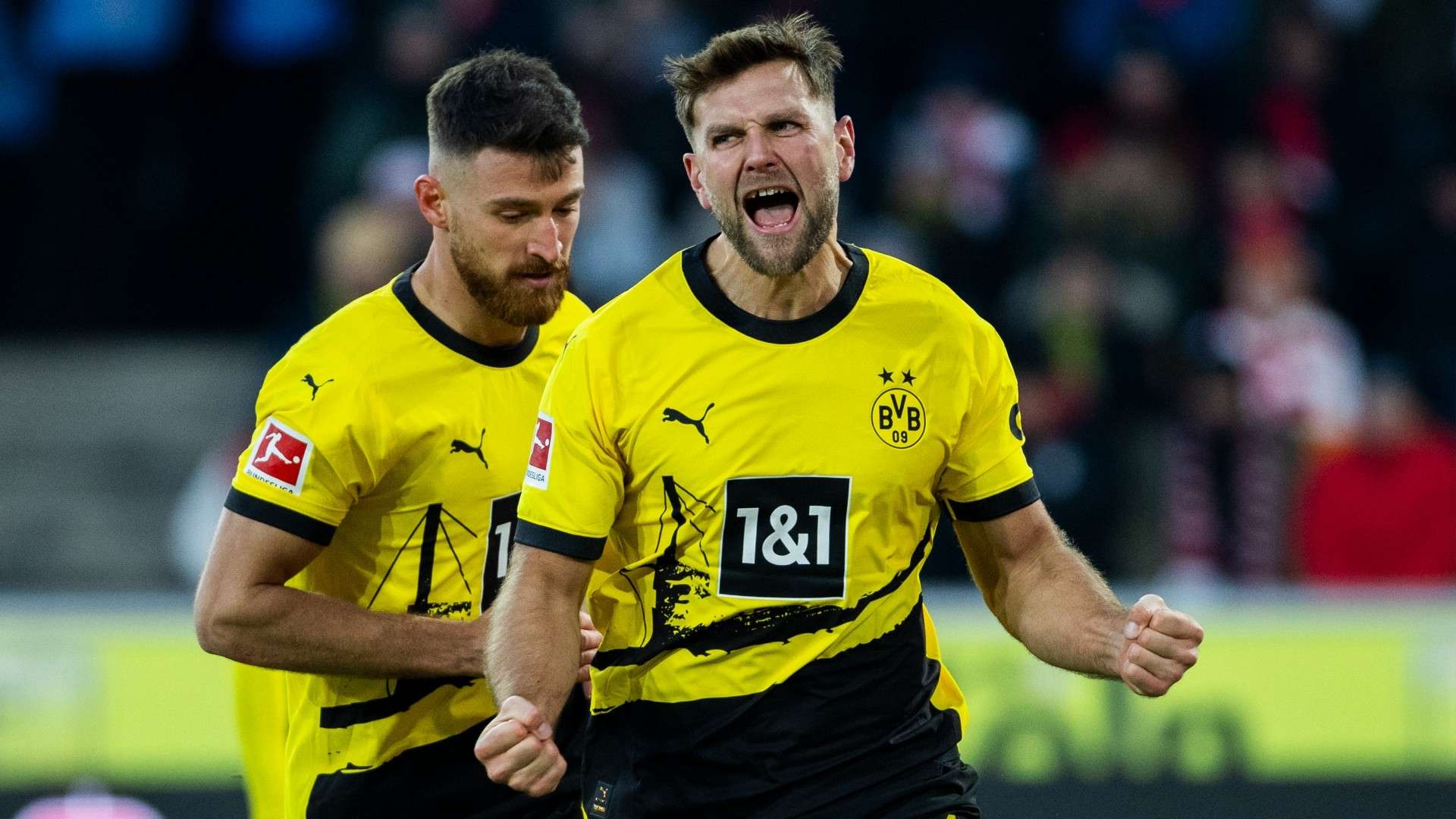 Niclas Fuellkrug of Dortmund celebrates Salih Oezcan of Dortmund